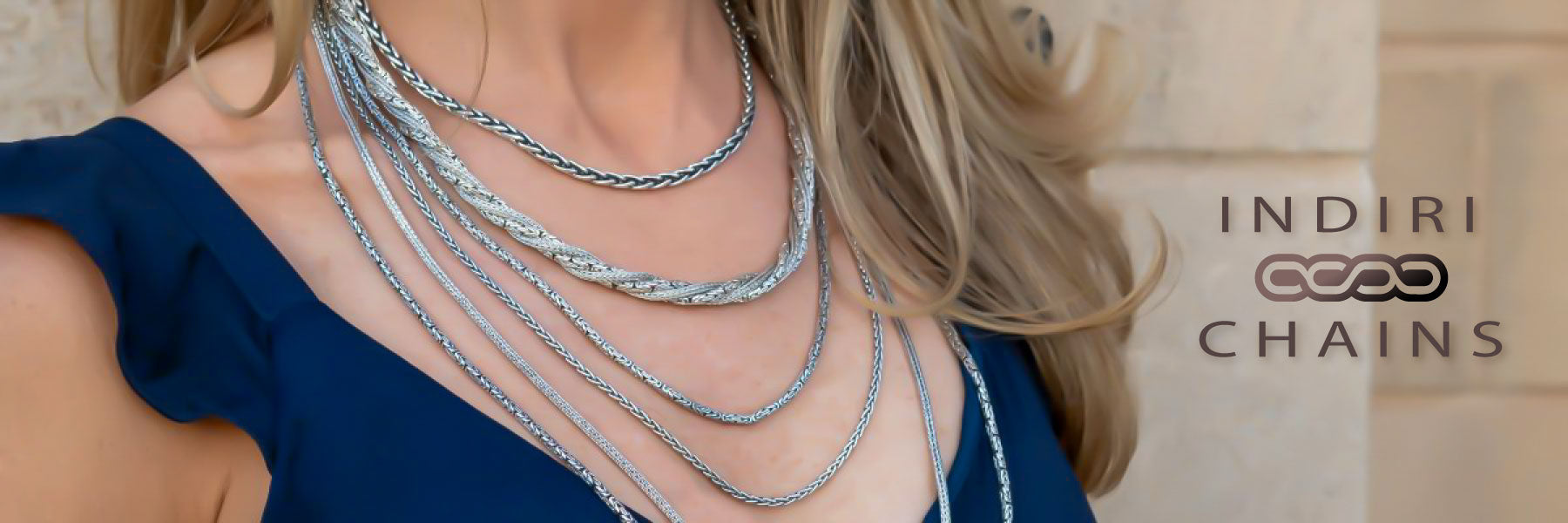 Woman wearing multiple handmade silver chains.