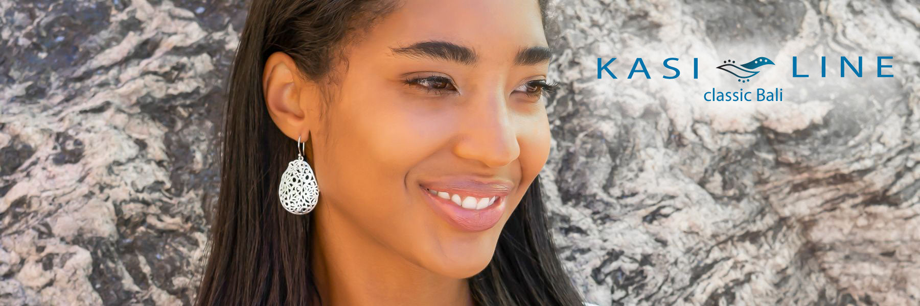Woman wearing carved sterling silver earrings.