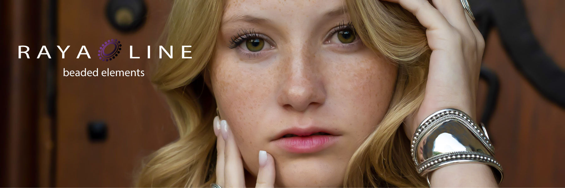 Woman wearing a beaded and mirrored sterling silver cuff bracelet.