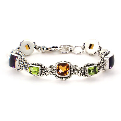 Clasped silver link bracelet with beaded links holding citrine, amethyst and peridot gemstones.