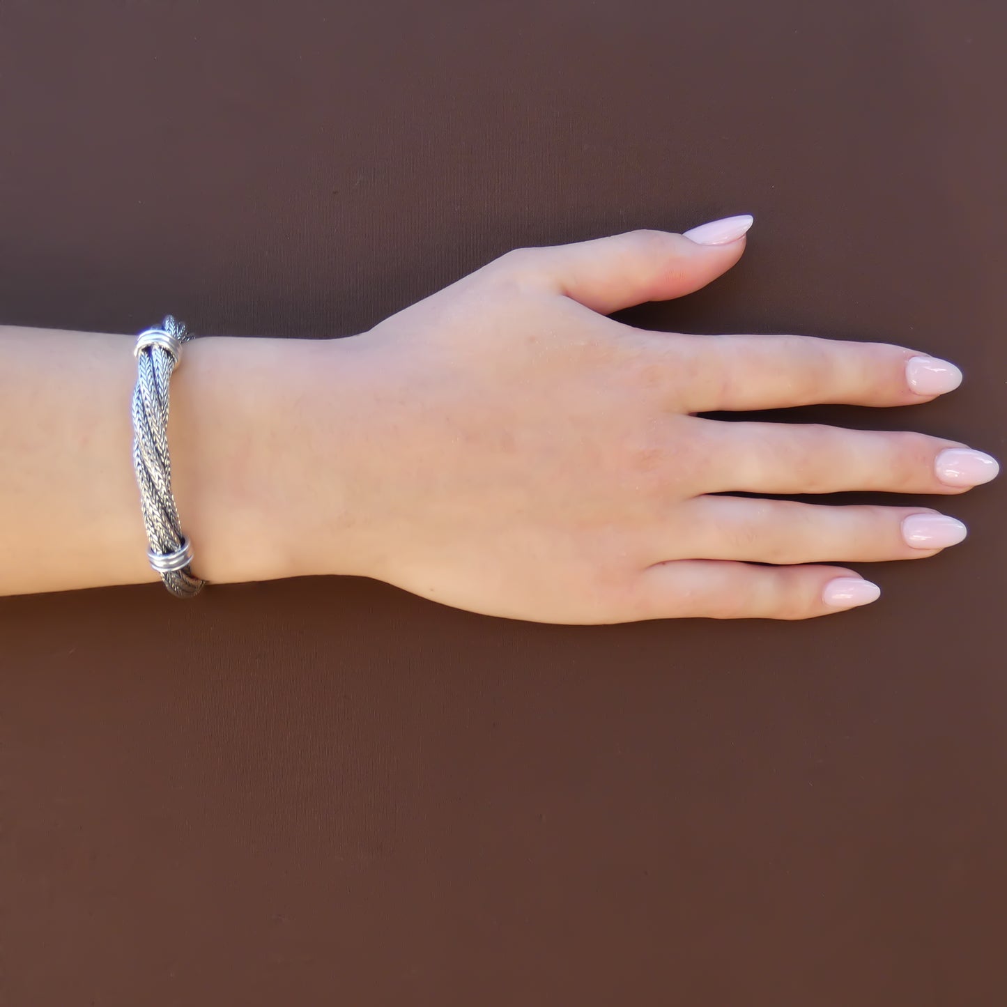 Woman wearing spiral twist chain bracelet.