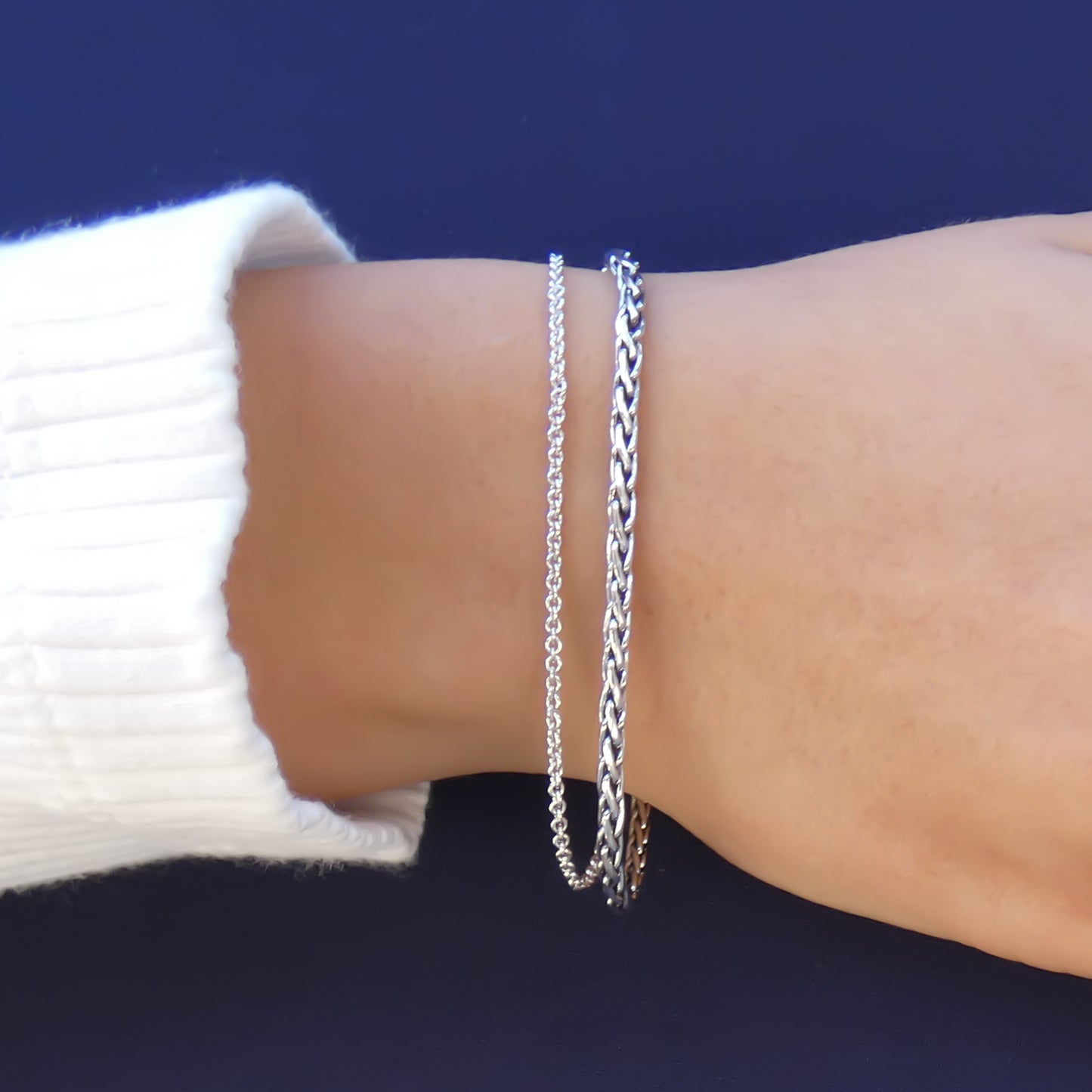 Woman wearing a double chain bracelet.