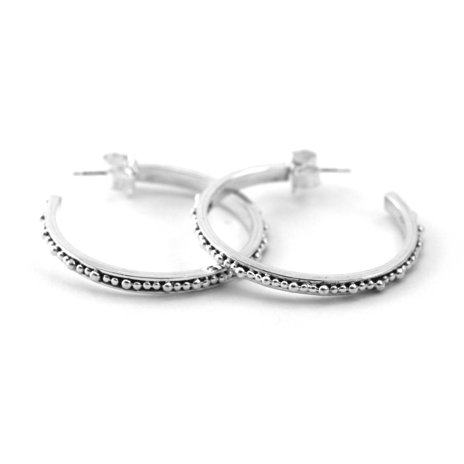 Sterling silver beaded hoops.