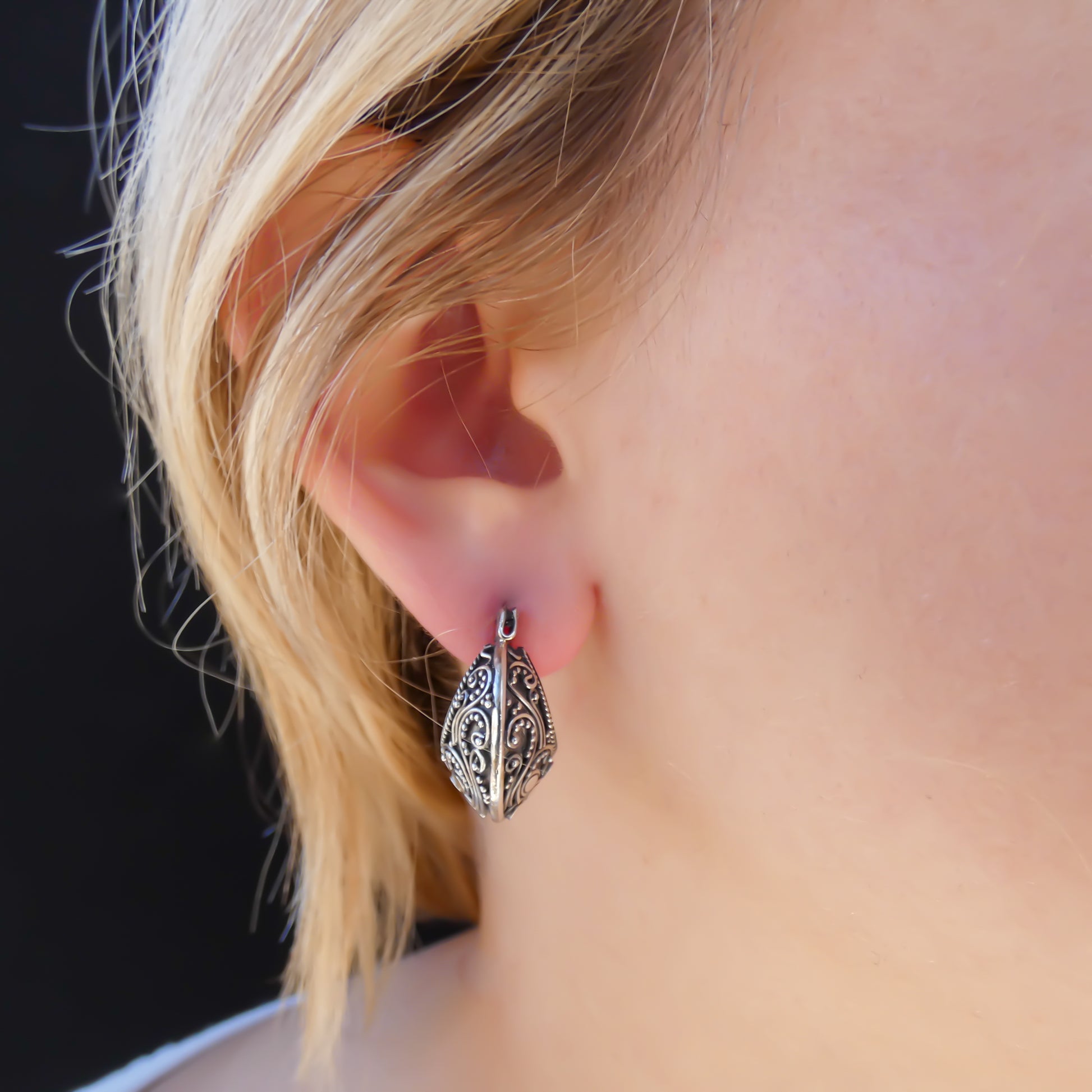 Sterling silver huggie filigree motif earrings.