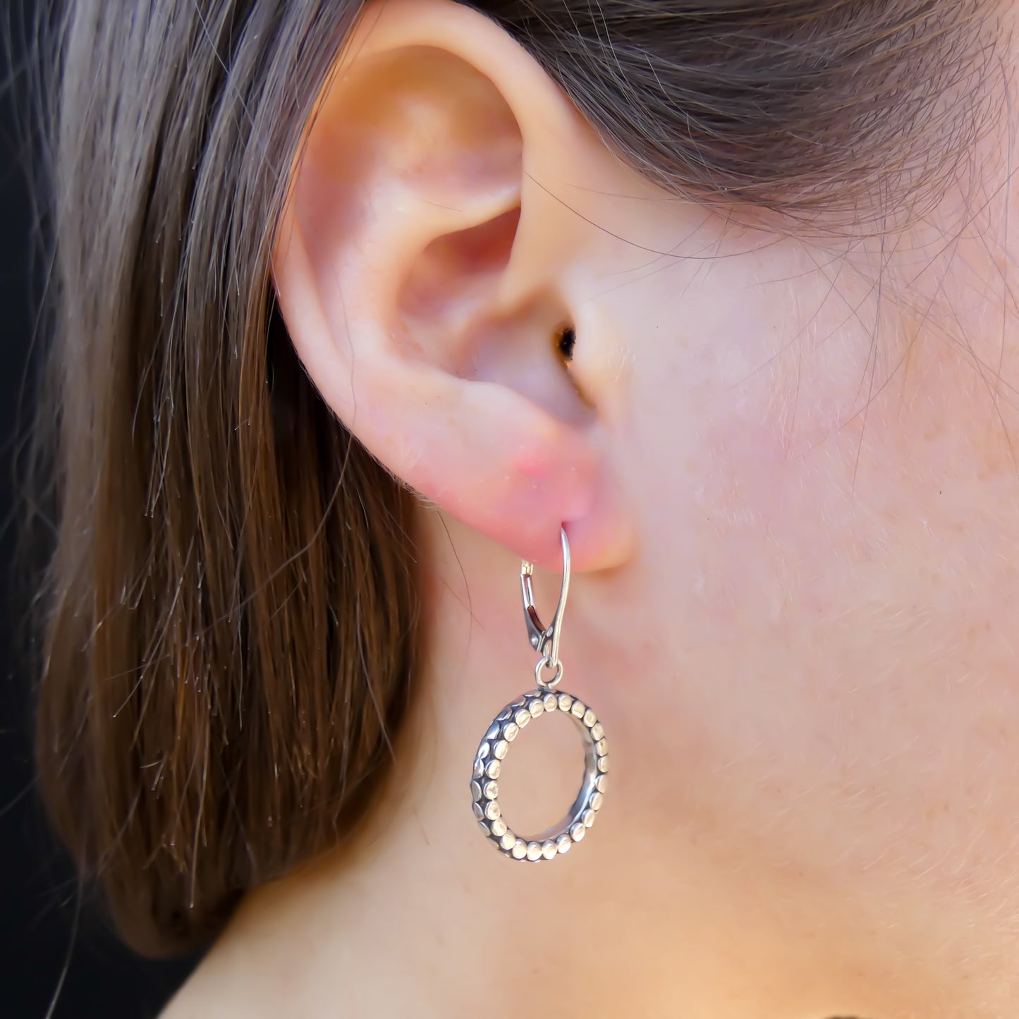 Sterling silver round ring dangle earrings.