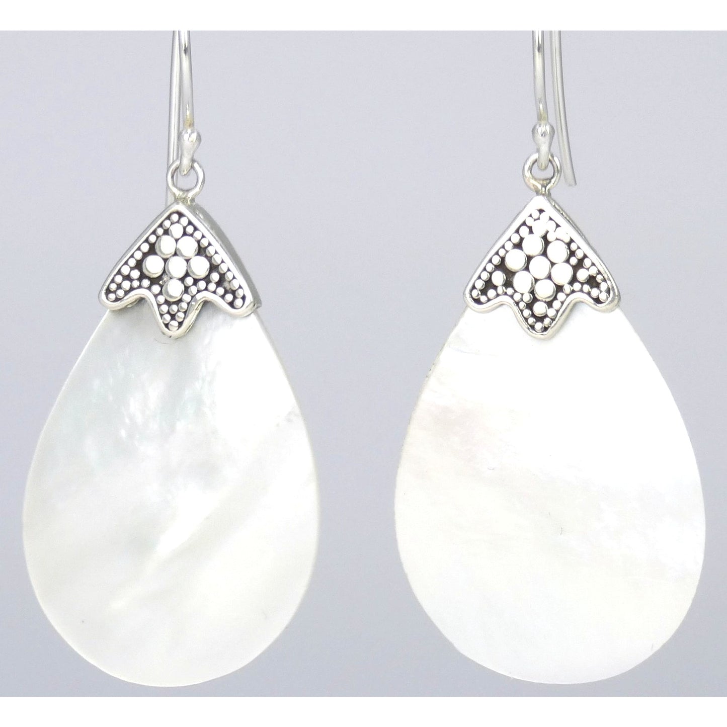 Silver earrings with large teardrop shaped shells.