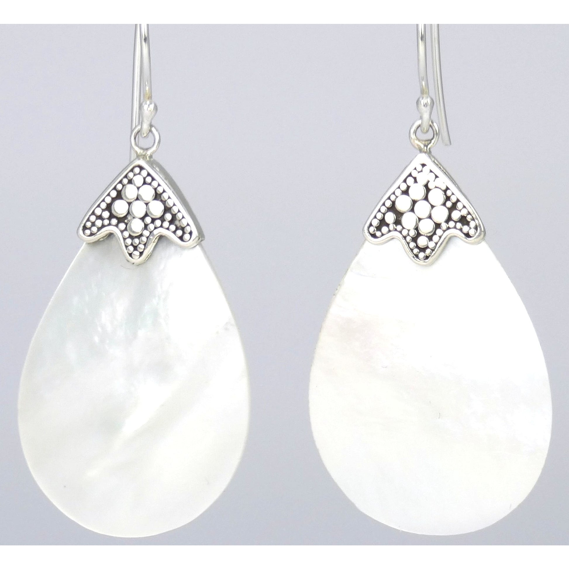 Silver earrings with large teardrop shaped shells.