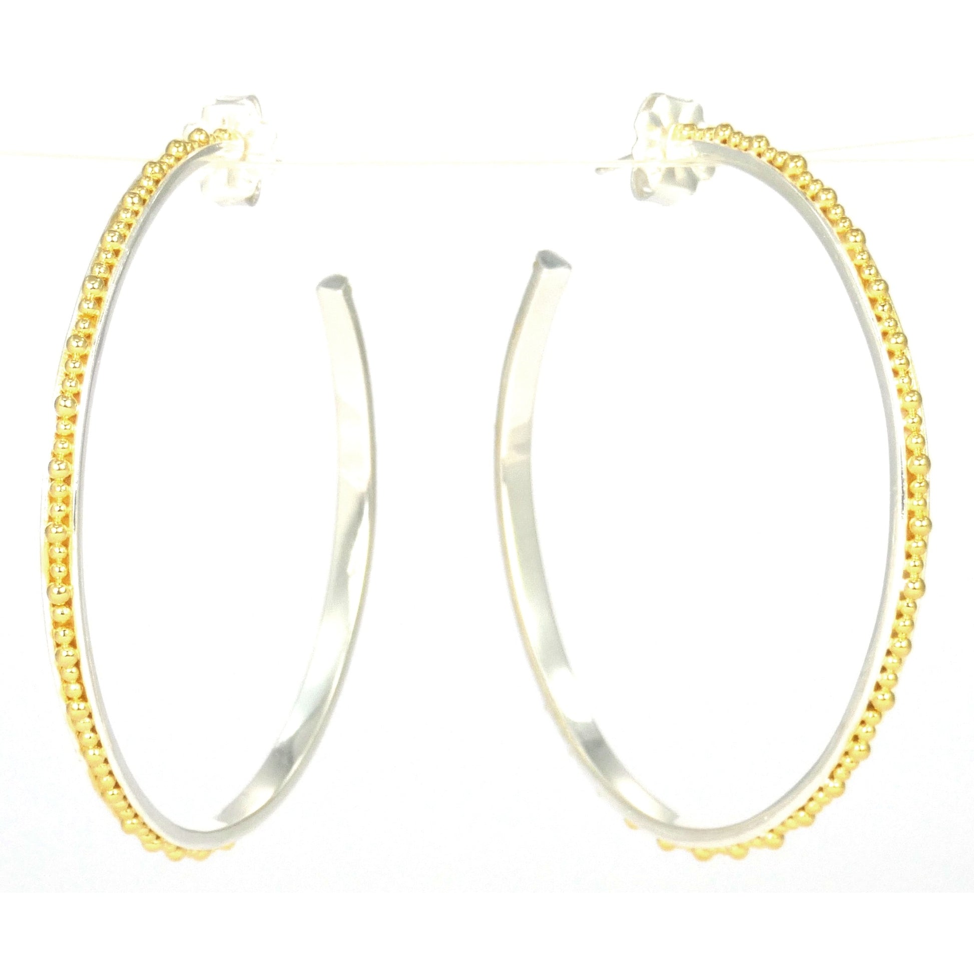 Sterling silver and gold large beaded hoops.