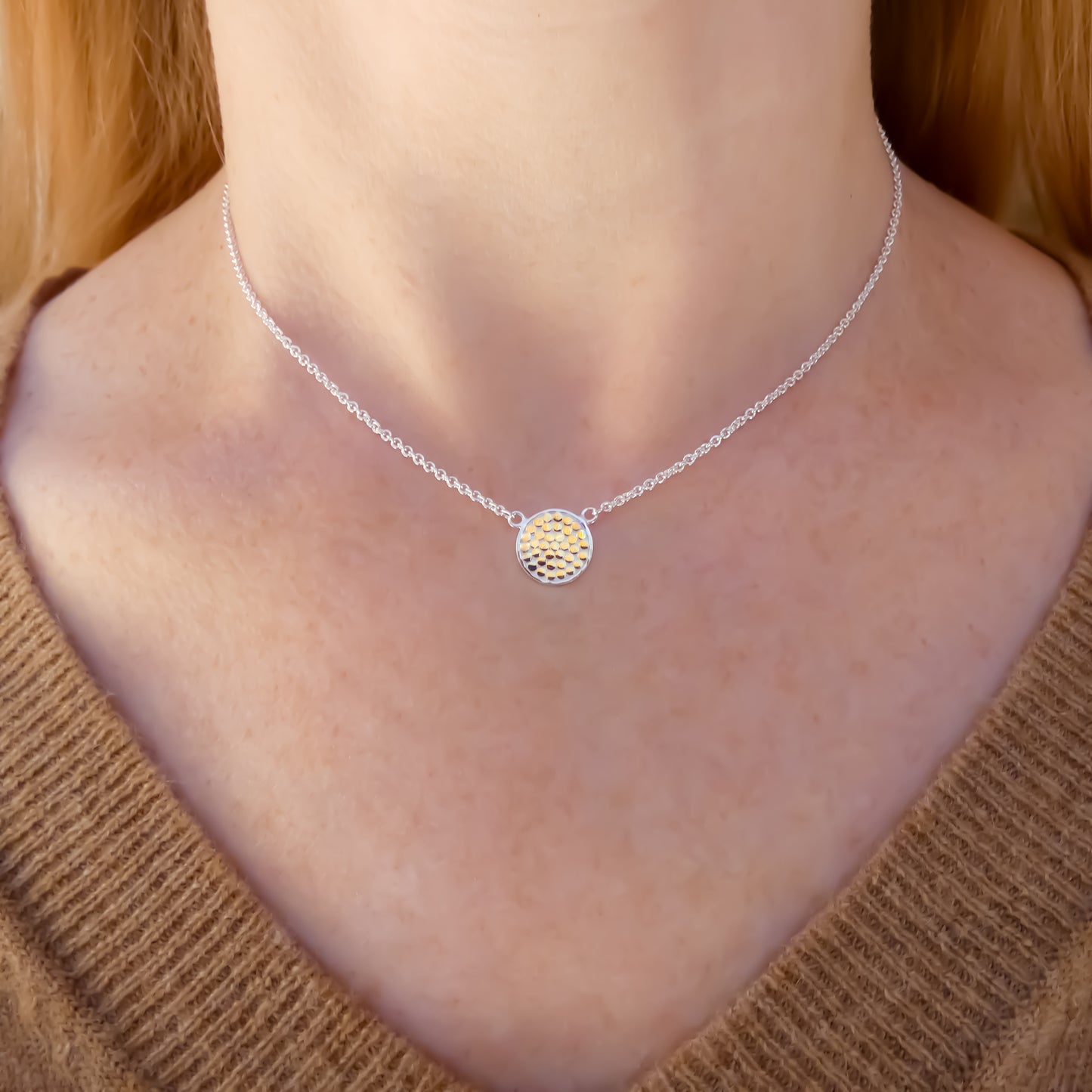 Sterling silver and gold necklace with lightweight chain and dotted disc.