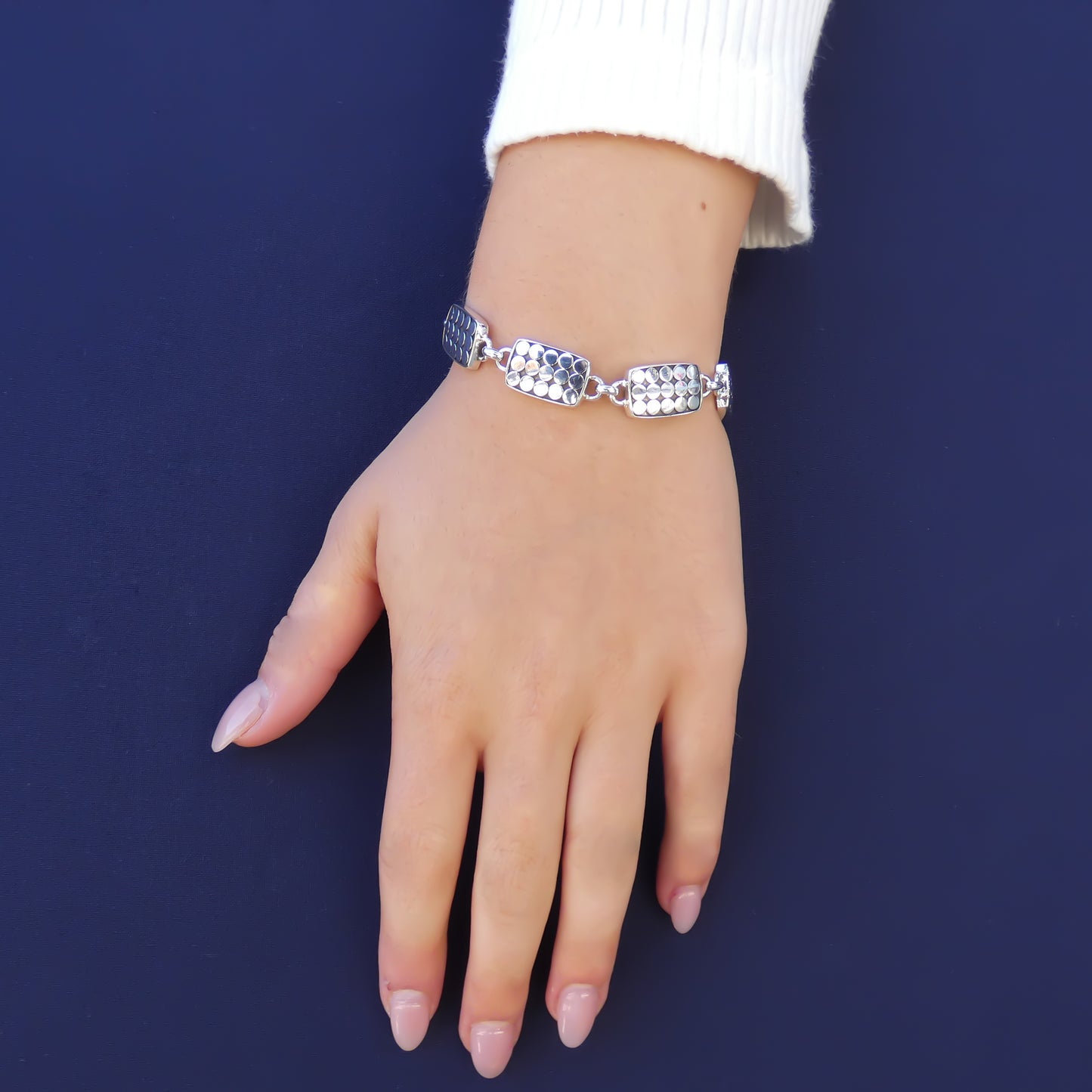 Sterling silver link bracelet with dot motif.