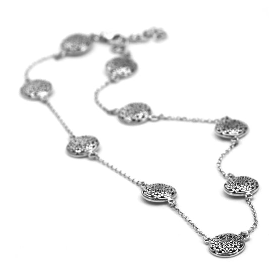 Sterling silver necklace with lightweight chain and round filigree design stations.