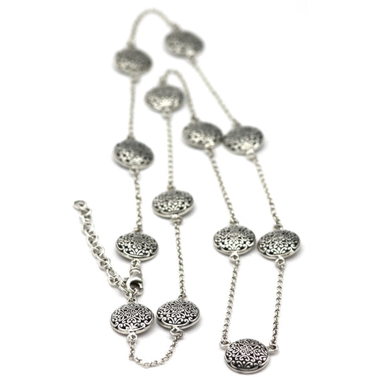 Sterling silver necklace with lightweight chain and round filigree design stations.