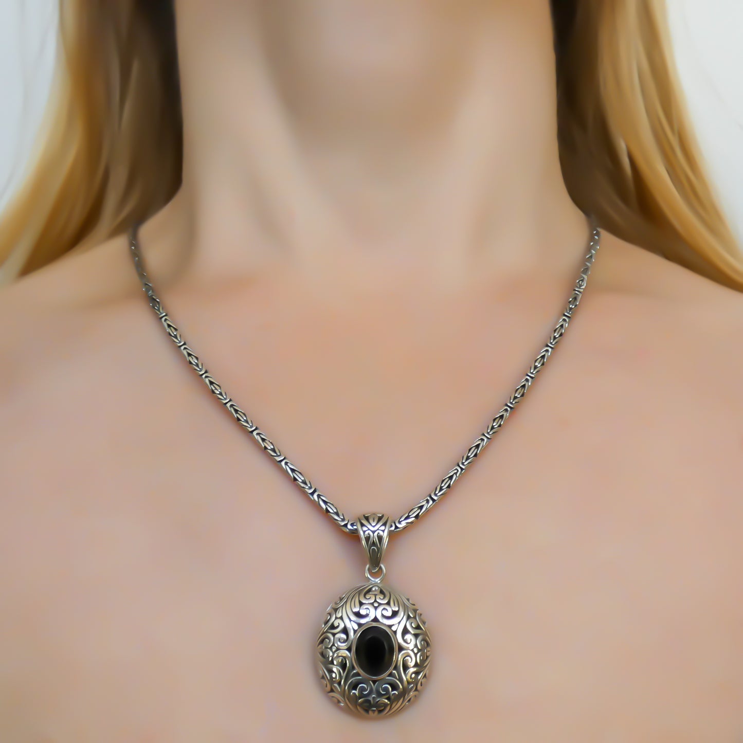 Sterling silver and faceted onyx pendant.