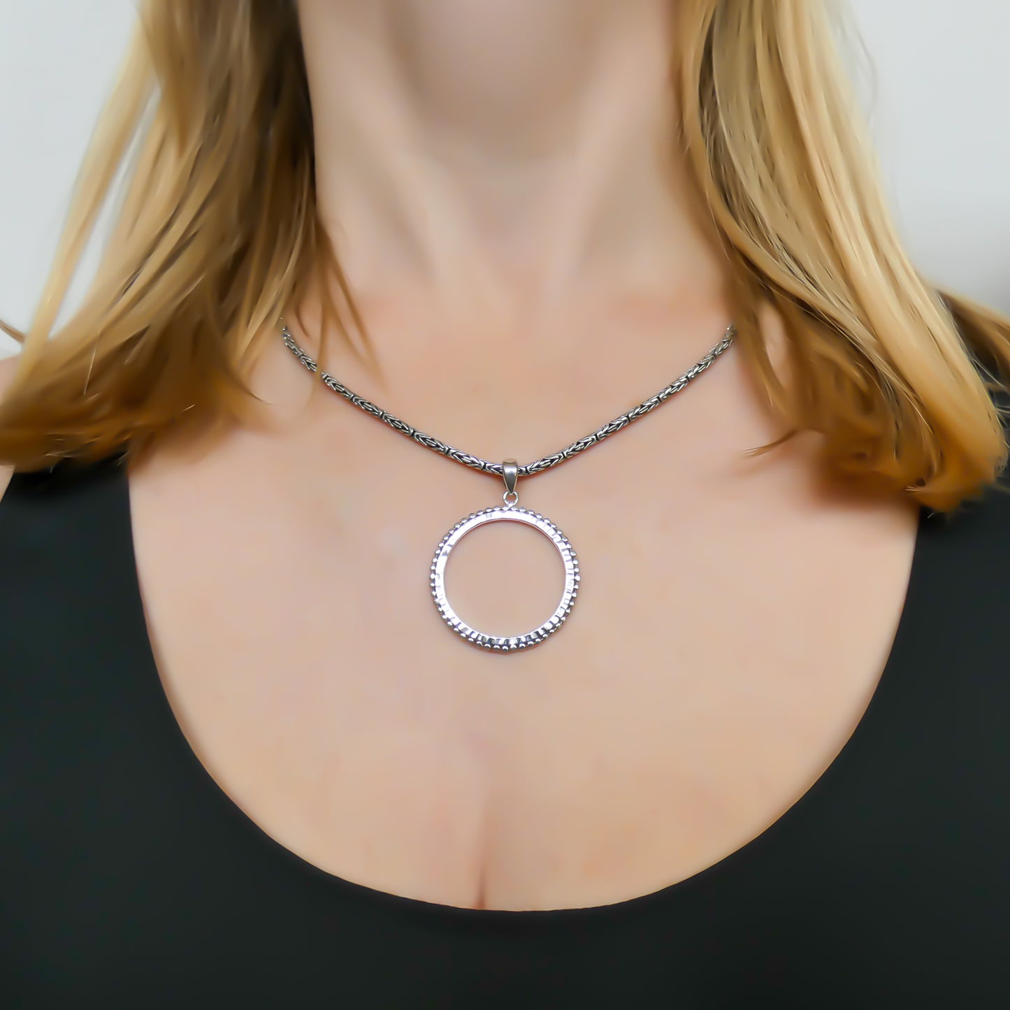 Sterling silver circle pendant.