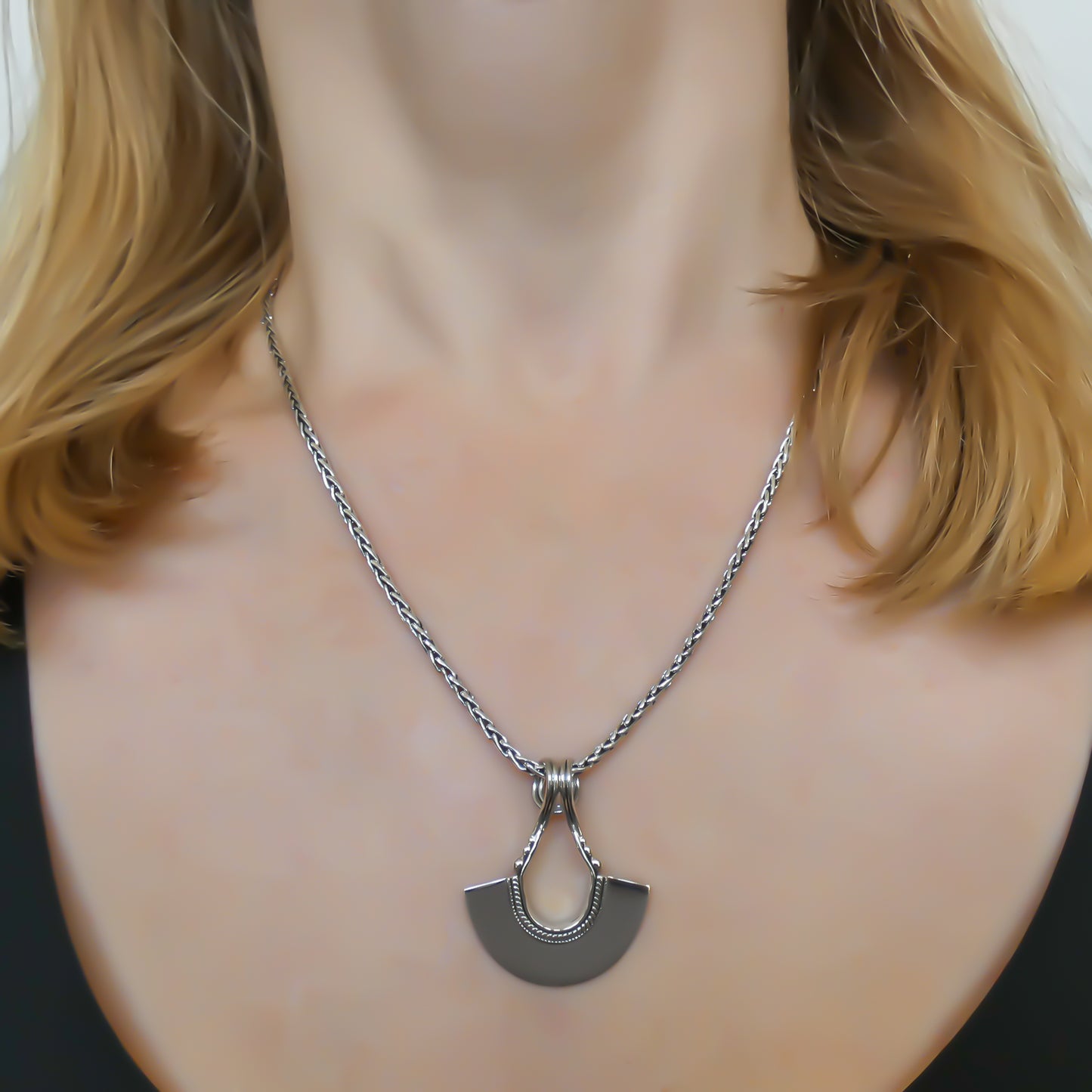 Sterling silver fan motif pendant.