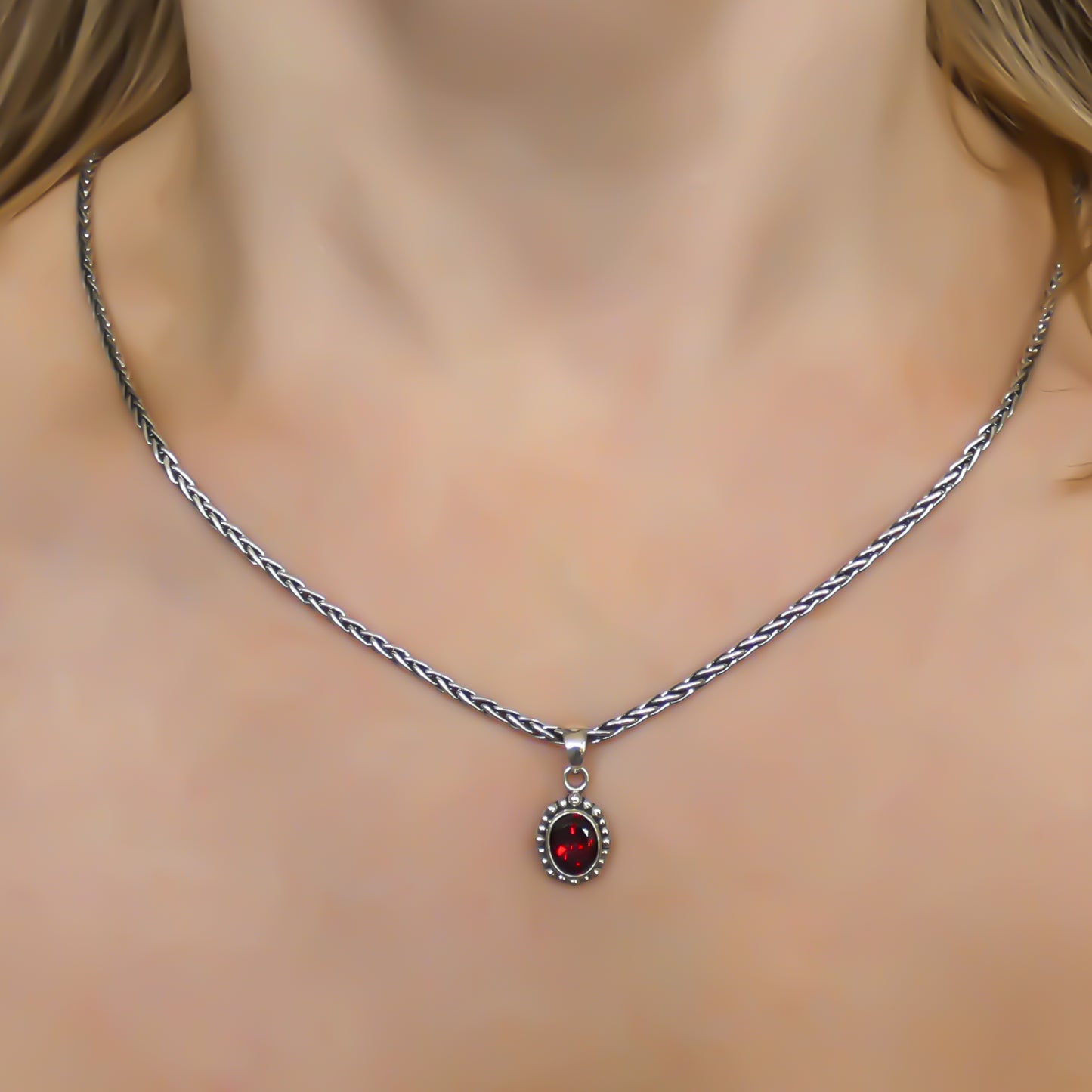 Sterling silver and oval garnet pendant.