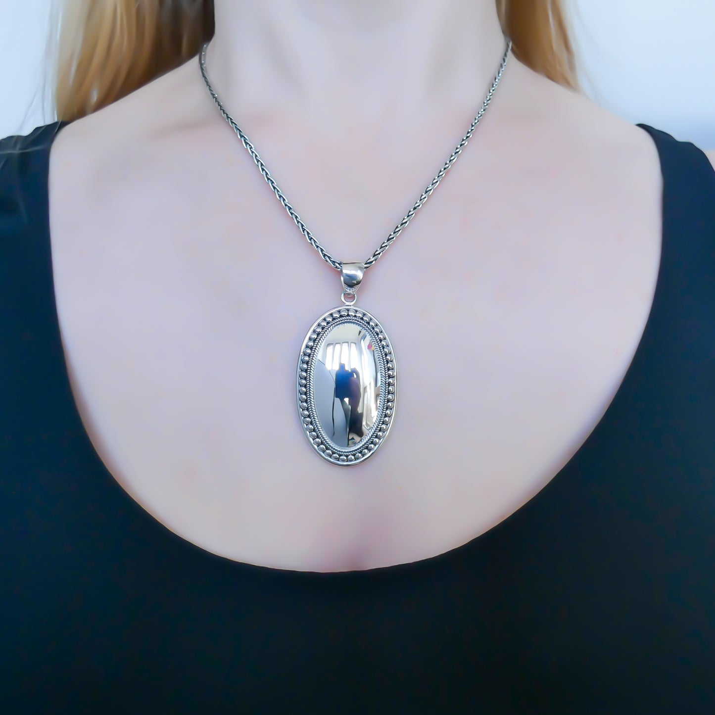 Sterling silver mirror dome pendant.