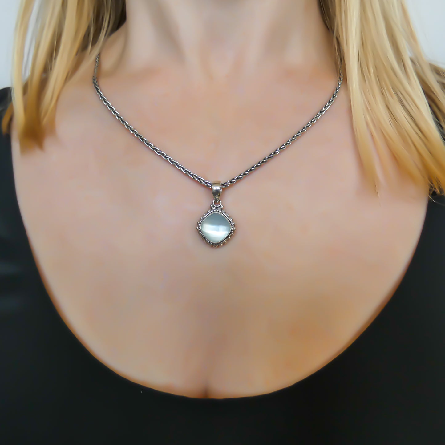 Sterling silver and mother of pearl doublet pendant.