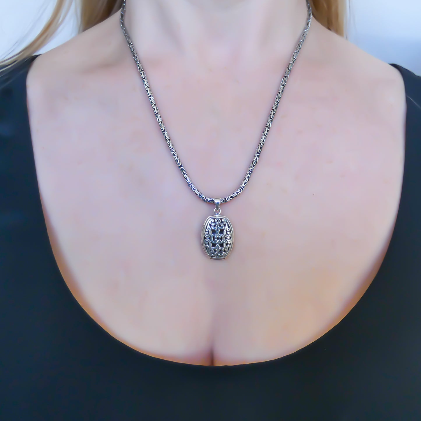 Sterling silver floral carved pendant.