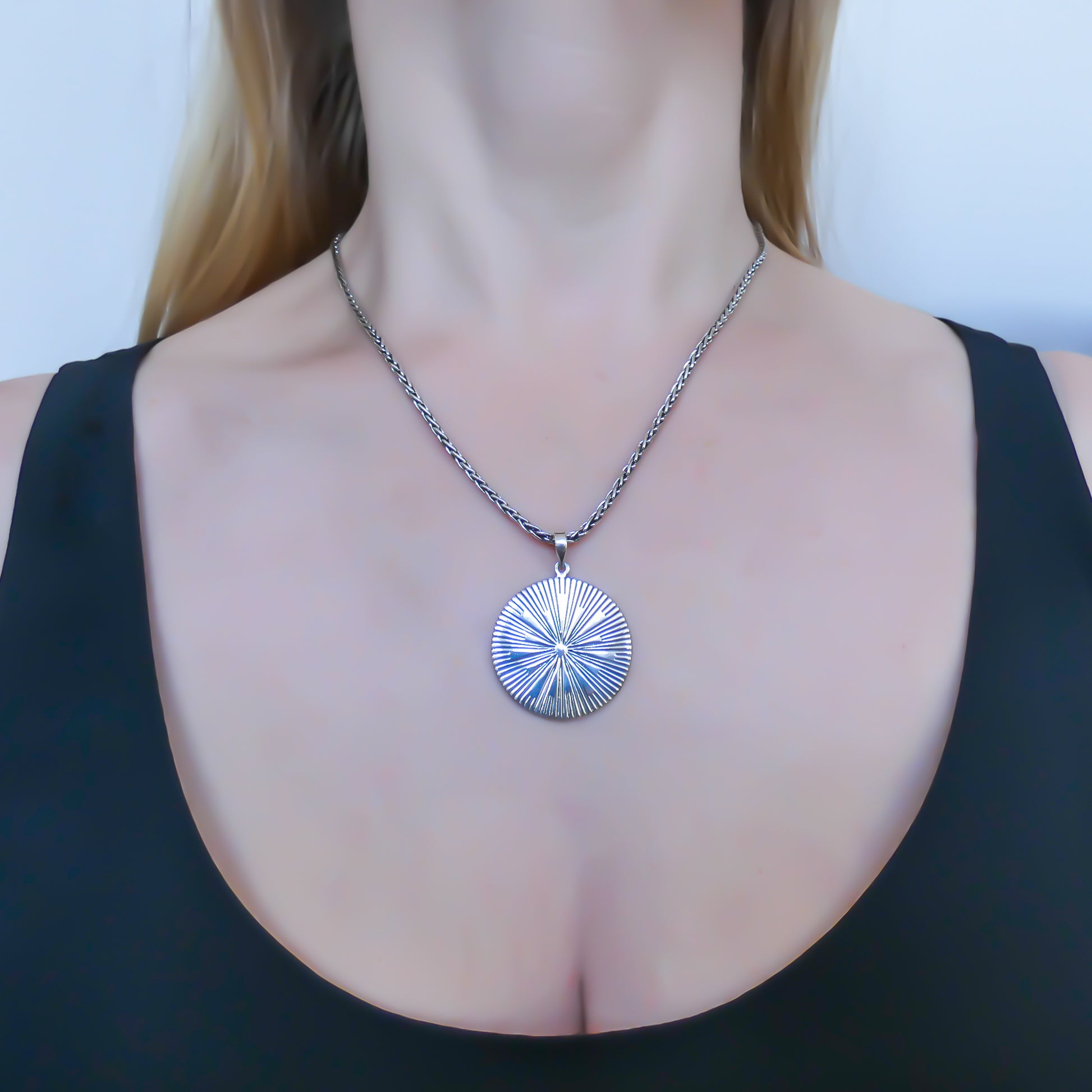 Sterling silver sun motif pendant.