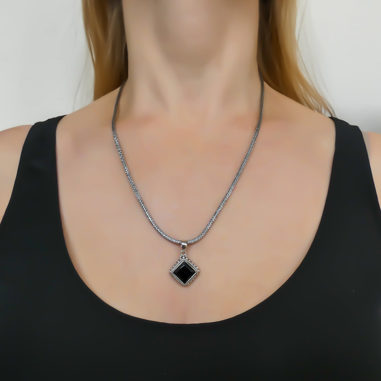 Sterling silver and faceted black onyx pendant.