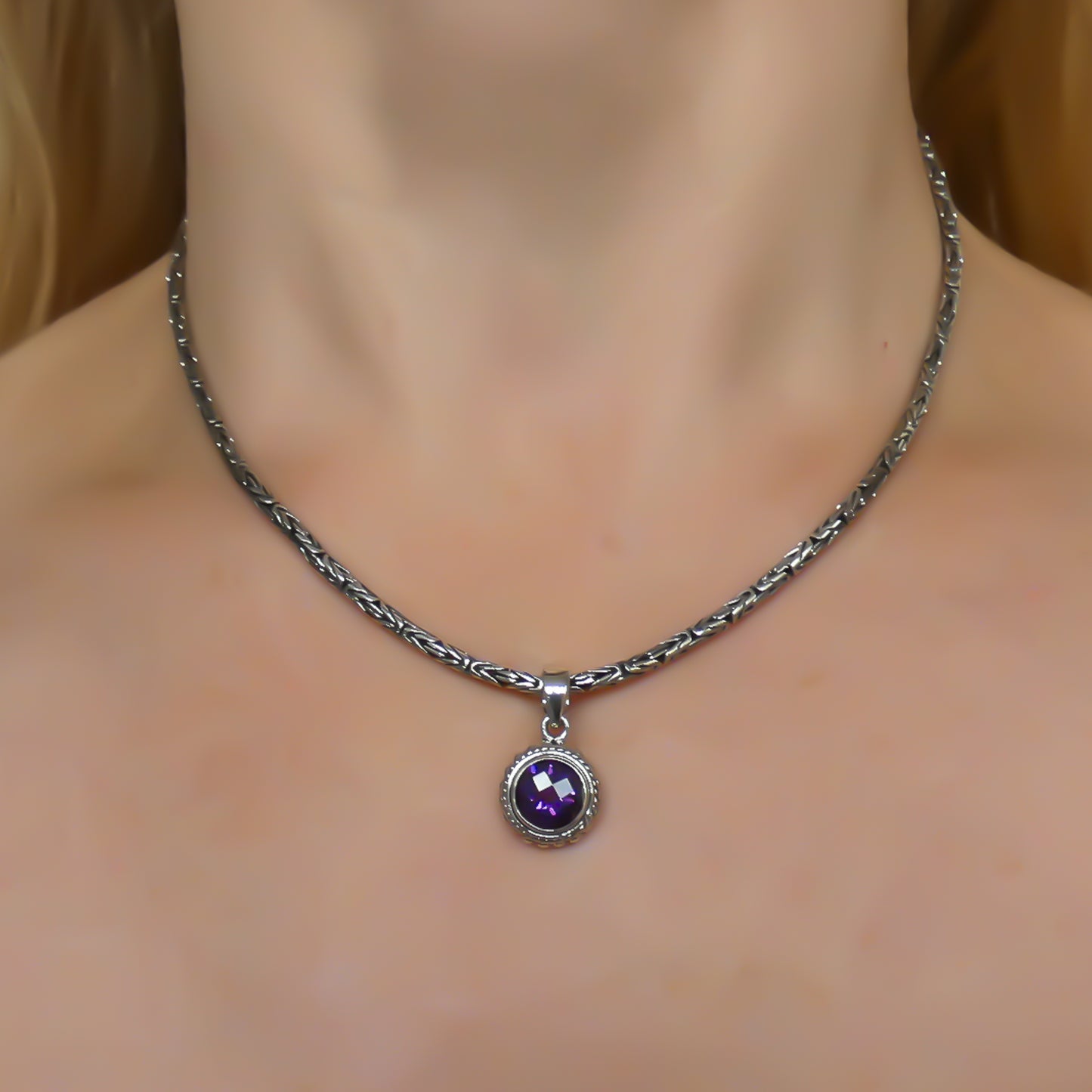 Sterling silver and round amethyst pendant.