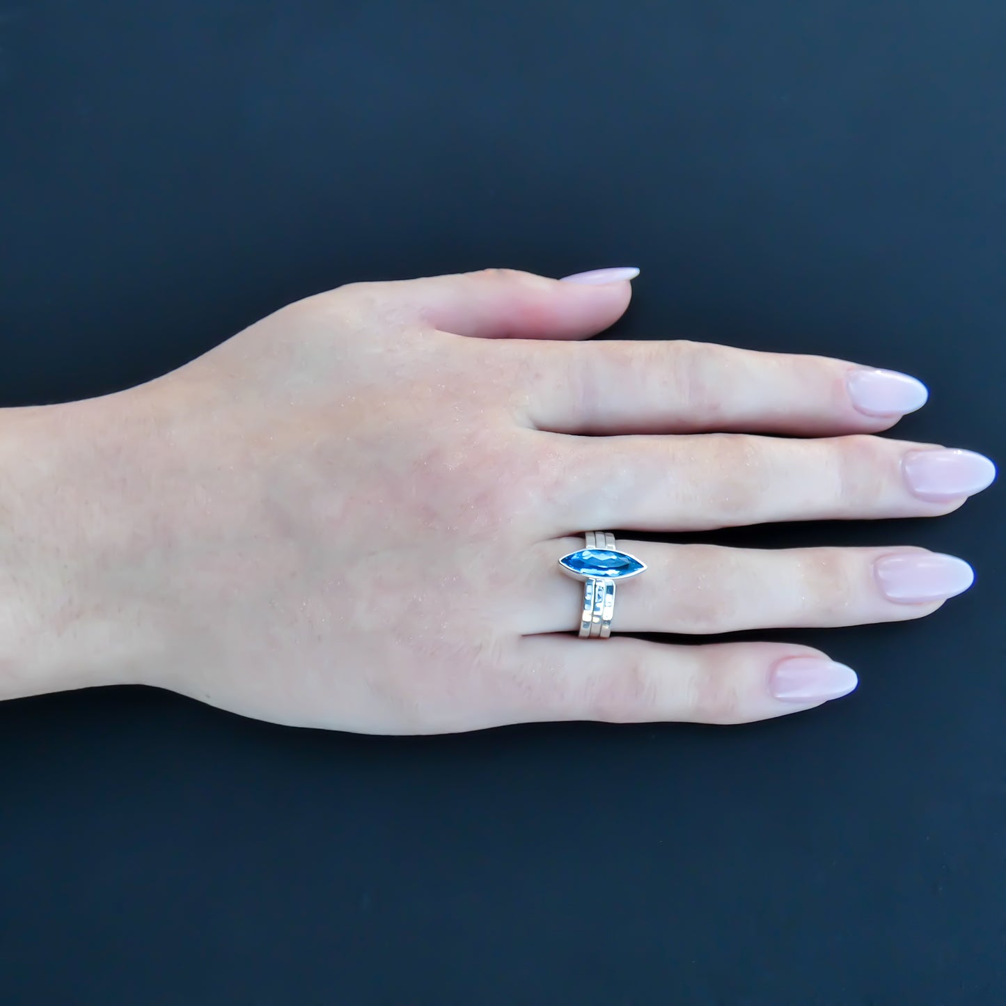 Sterling silver ring set with Swiss blue topaz marquis cut gemstone.