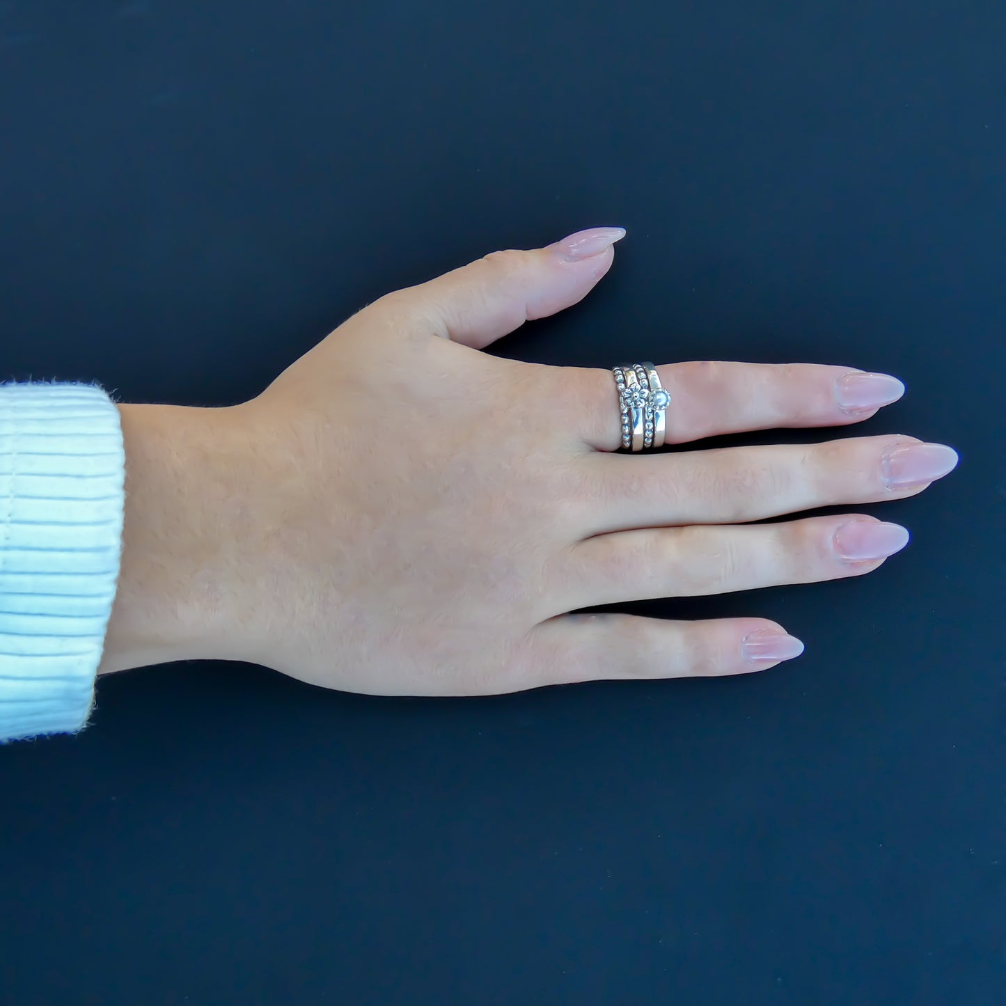 Sterling silver and pearl and flower motif.