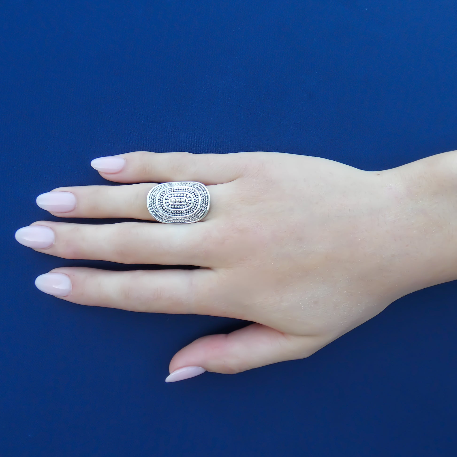 Sterling silver ring with handmade design motif.