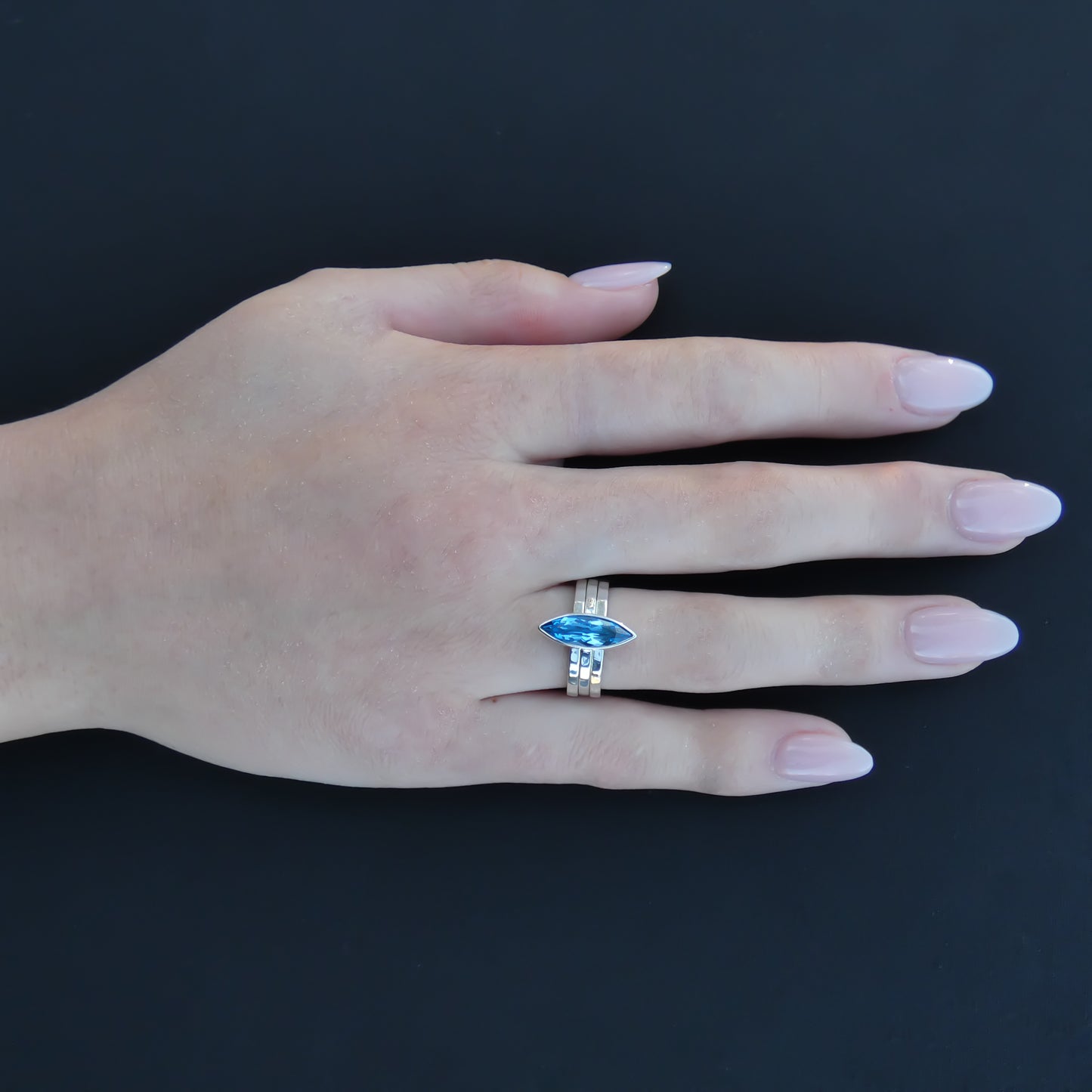 Sterling silver ring set with Swiss blue topaz marquis cut gemstone.