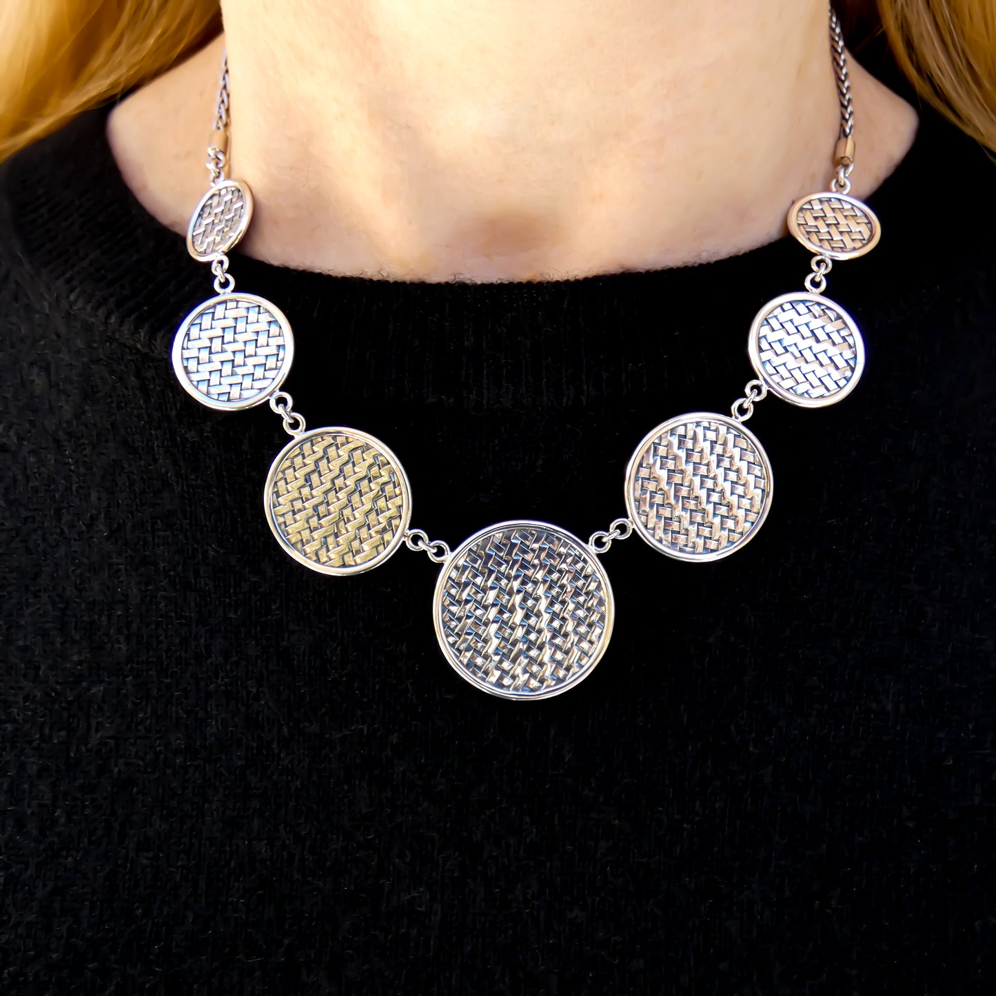 Sterling silver necklace with woven disc stations.
