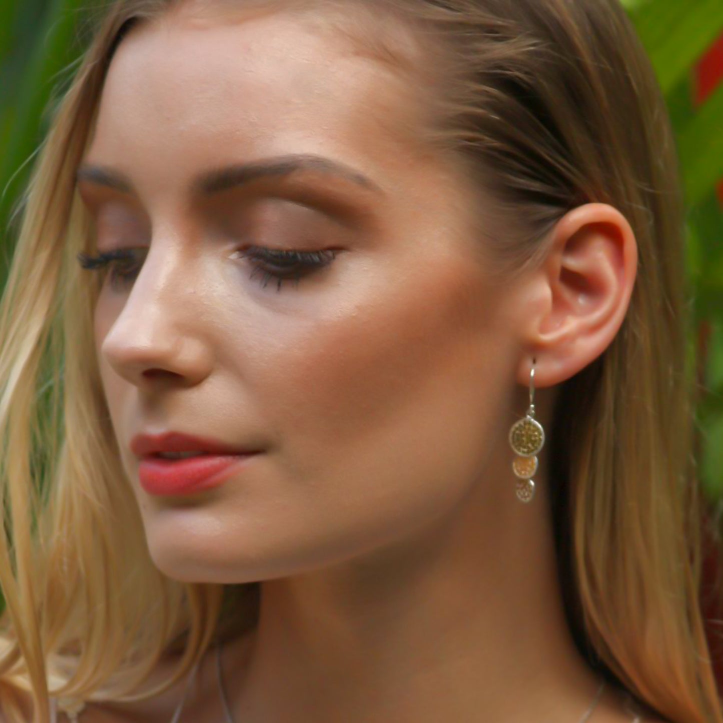 Sterling silver and gold dangle disc earrings.