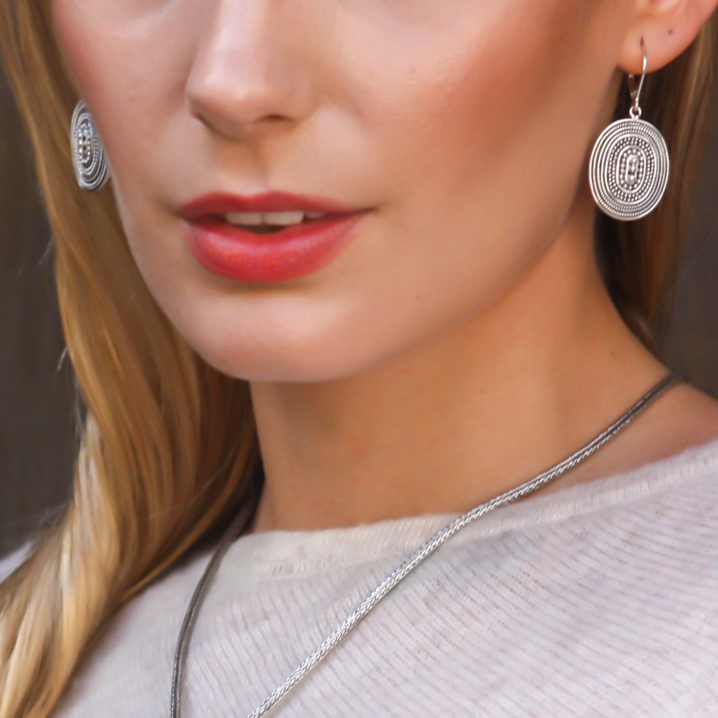 Sterling silver beaded oval earrings.