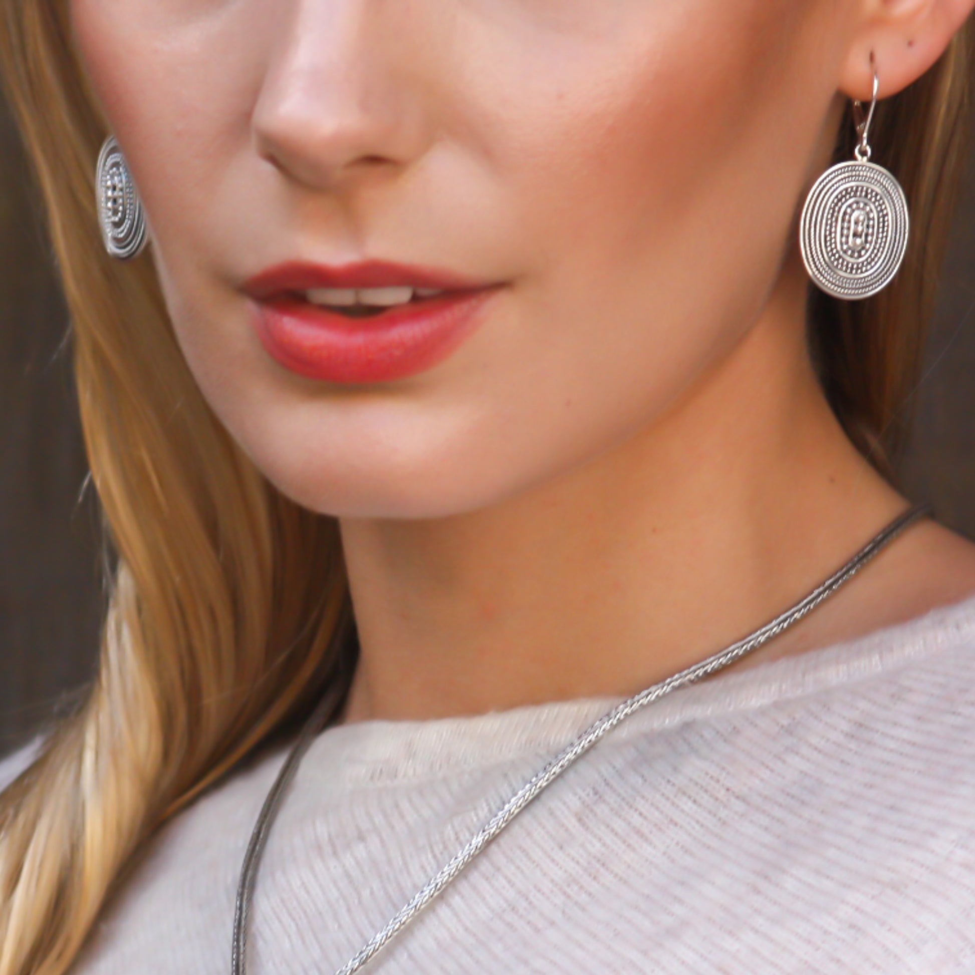 Sterling silver beaded oval earrings.