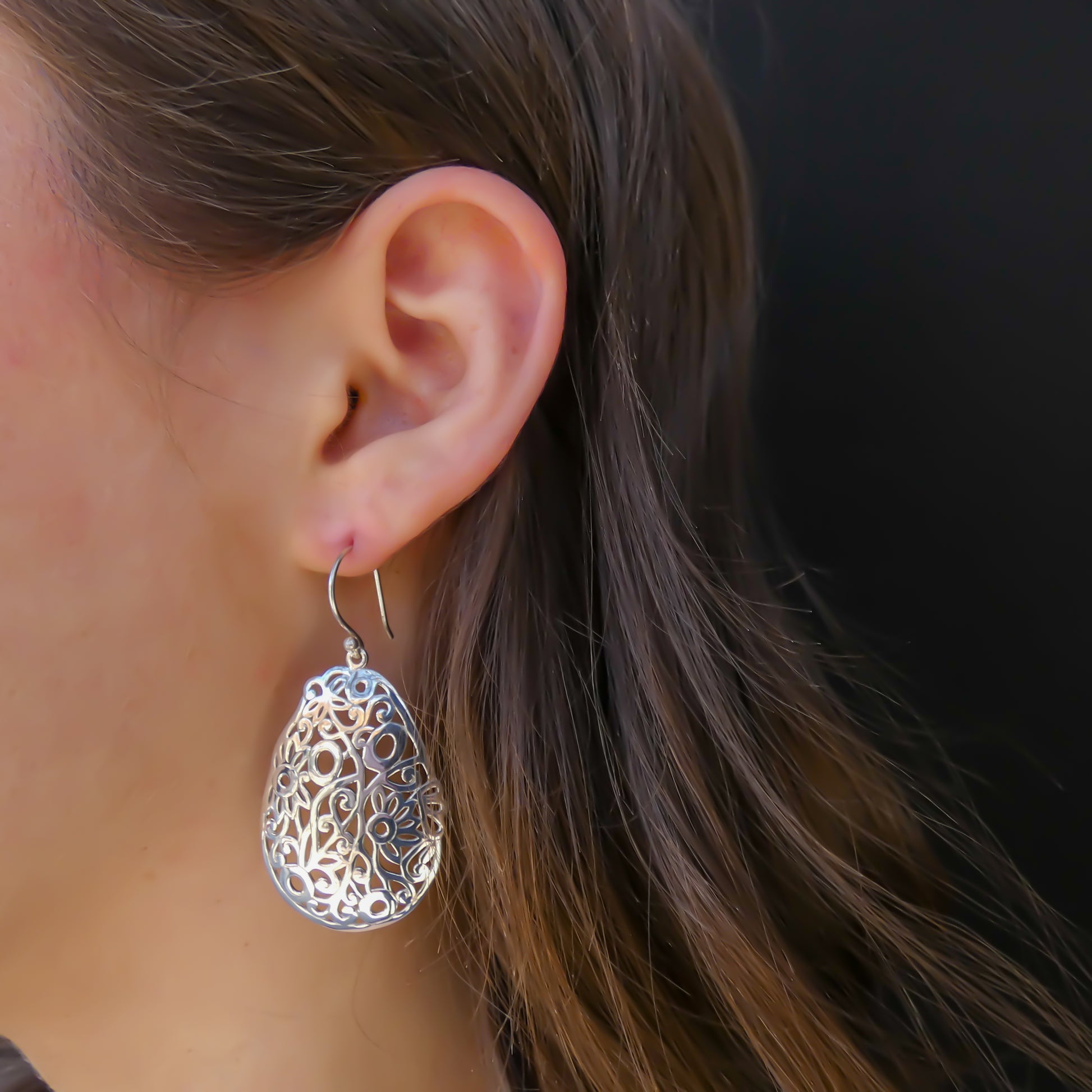 Sterling silver floral dangle earrings.