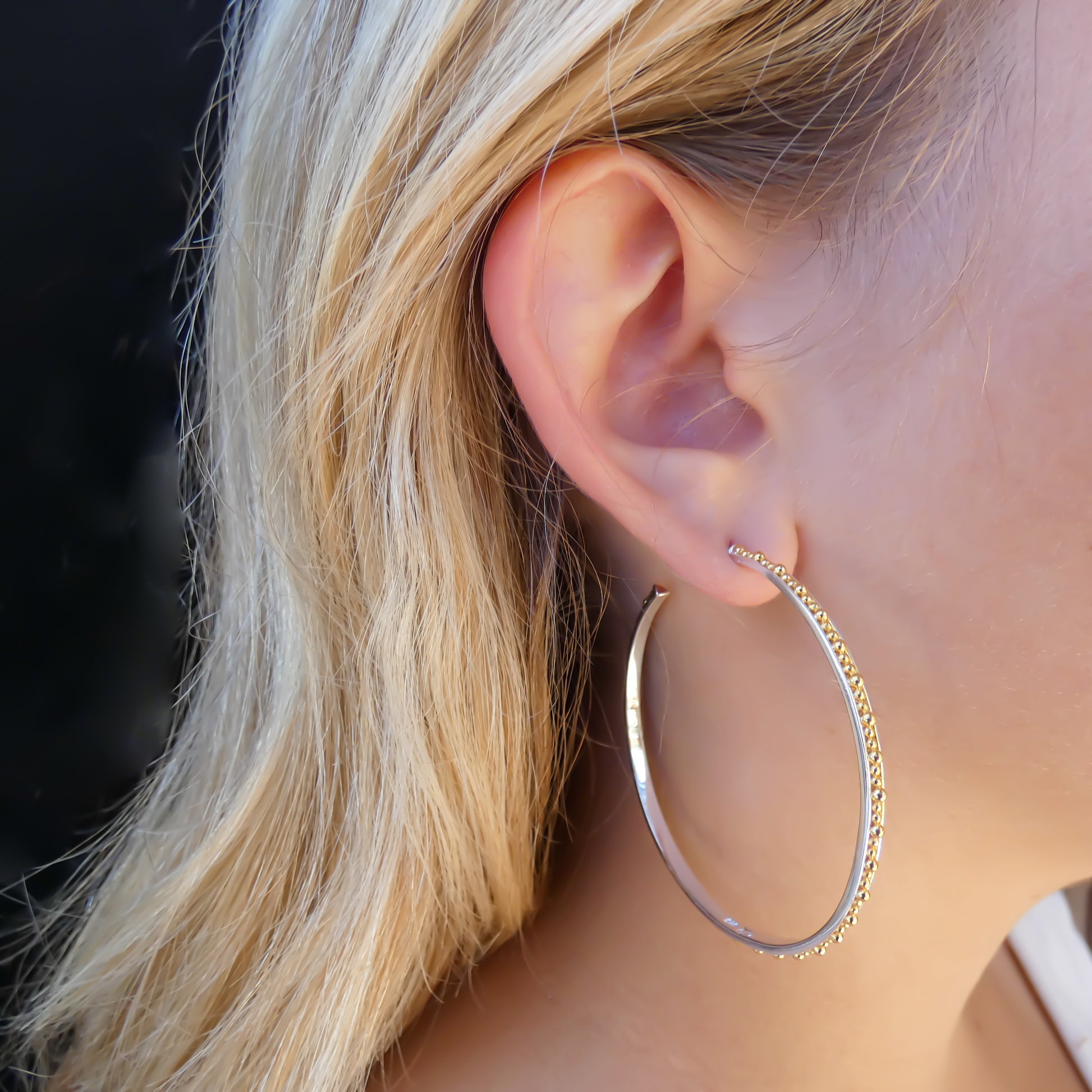 Sterling silver and gold large beaded hoops.