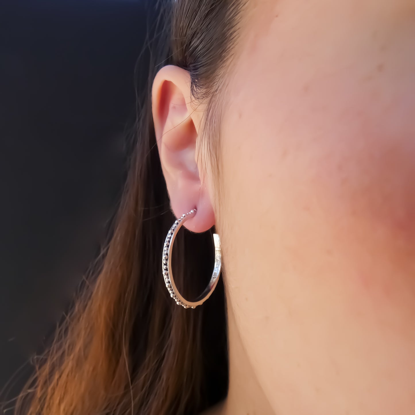 Sterling silver beaded hoops.