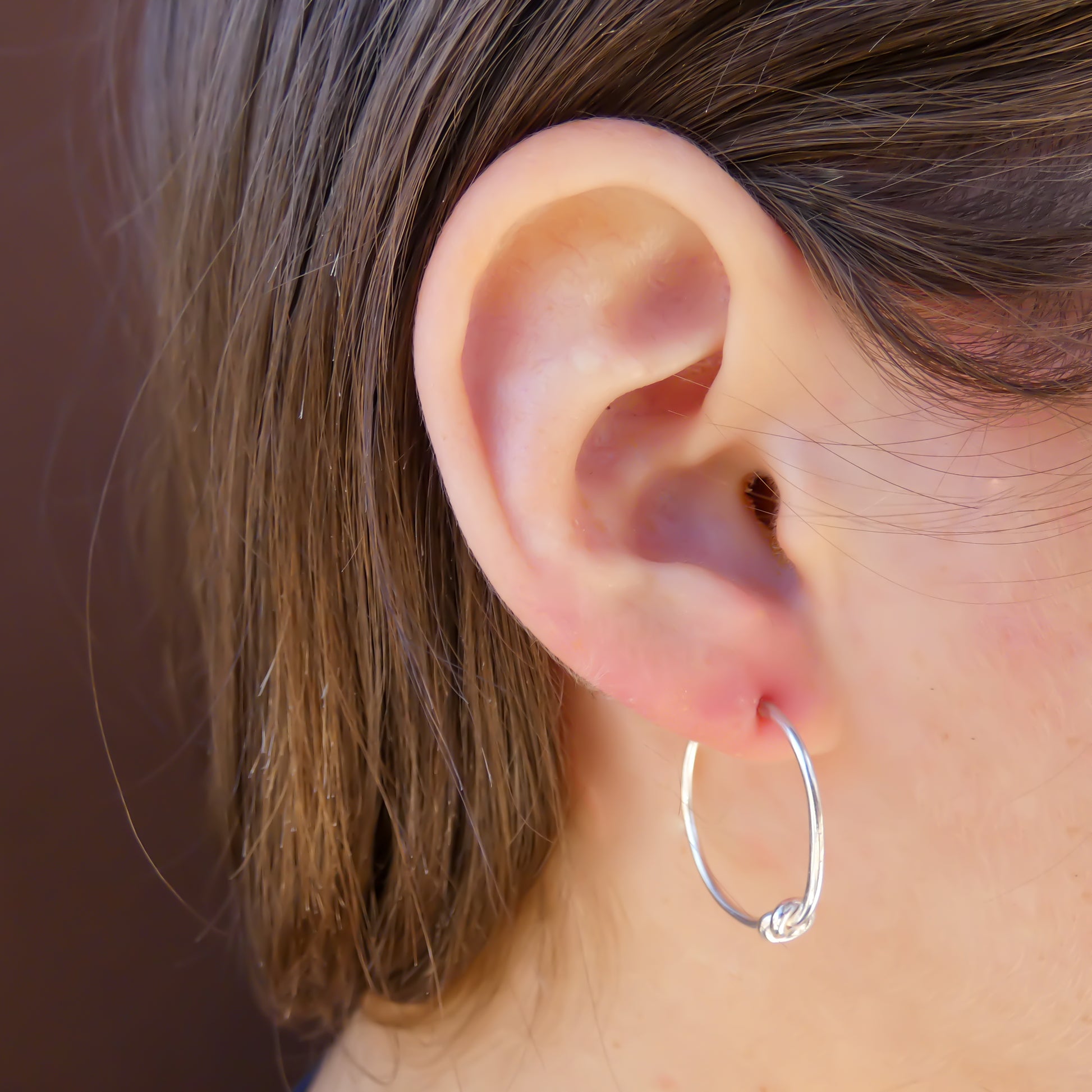 Sterling silver knot motif post earrings.
