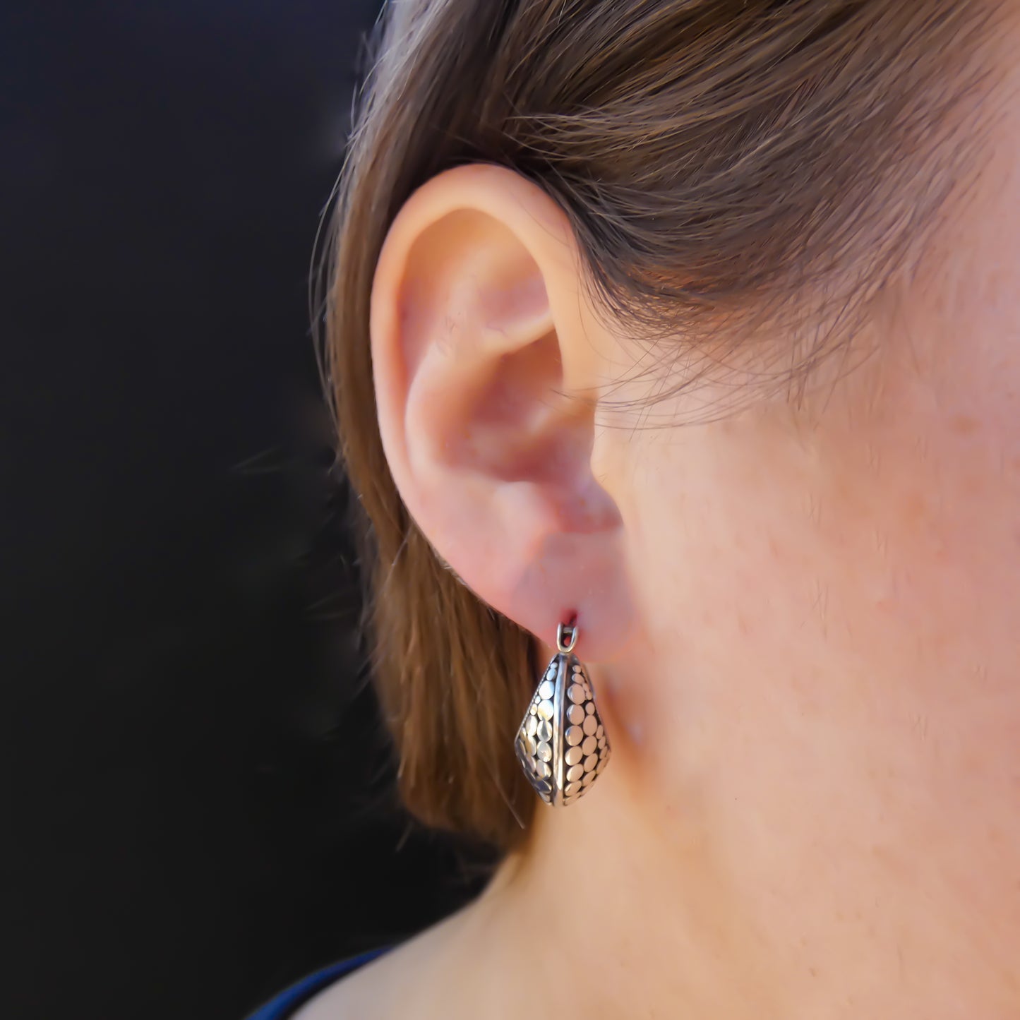 Sterling silver huggie dot motif earrings.