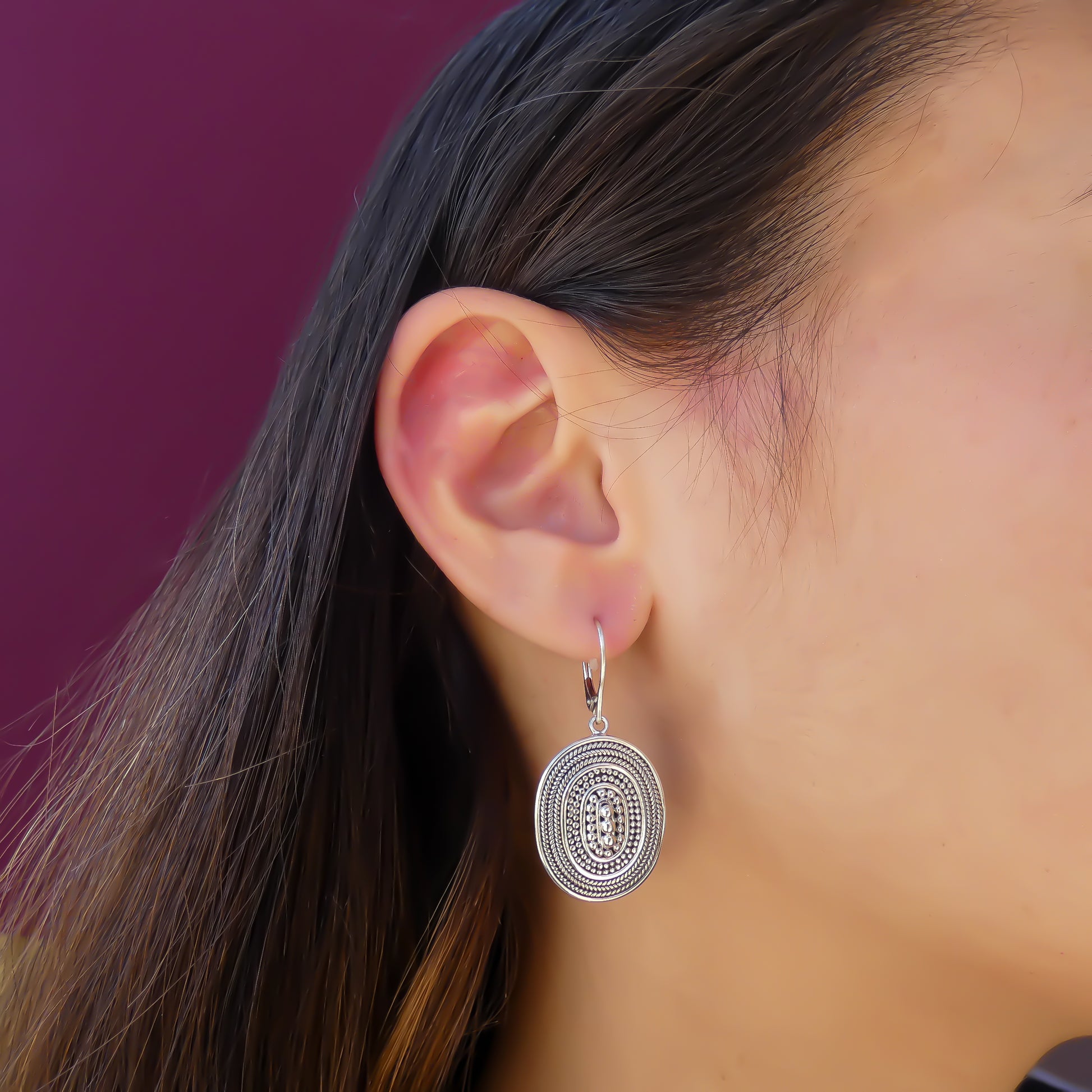 Sterling silver beaded oval earrings.