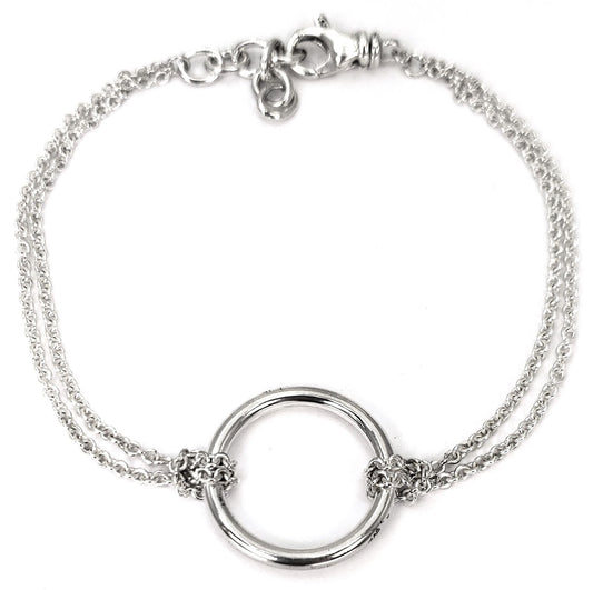 Silver bracelet with two thin machine-made chains and a polished ring in the middle.