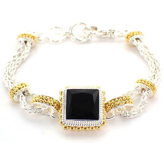 Silver and gold bracelet with square onyx gemstone in the center.