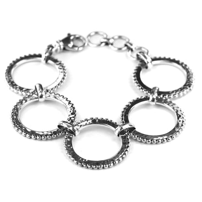 Silver bracelet made of five hammered and beaded rings.