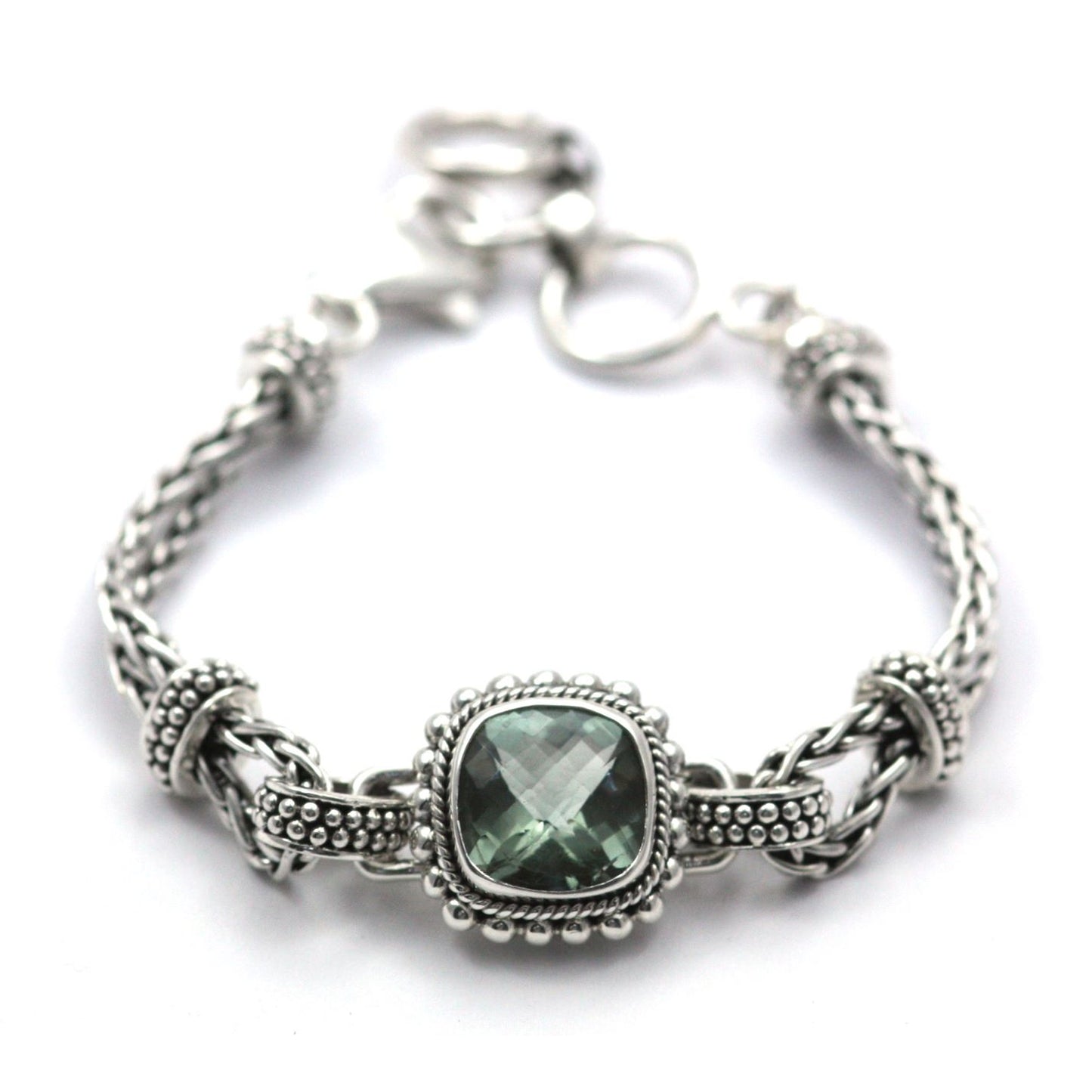 Silver bracelet with wheat chain arms and a centered station with one faceted green amethyst gemstone.
