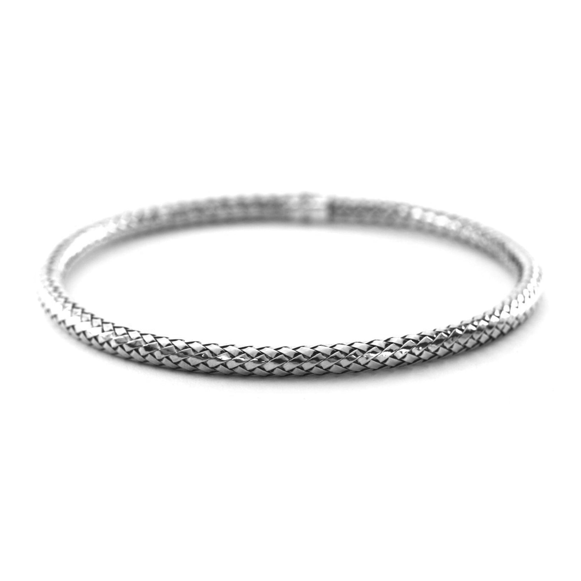 Tubular silver bangle bracelet made of woven silver strands.