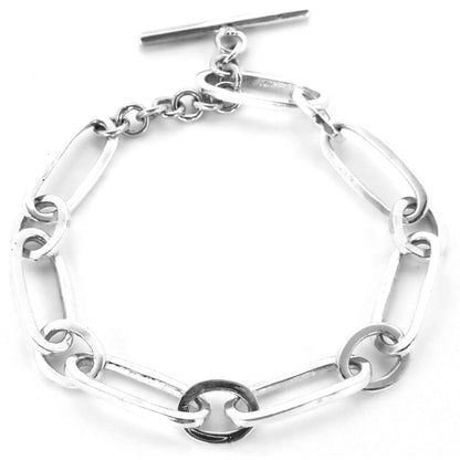 Silver high polish alternating link bracelet with toggle clasp.