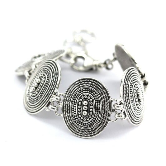 Silver bracelet made of five connected oval links with rope detail and beads.