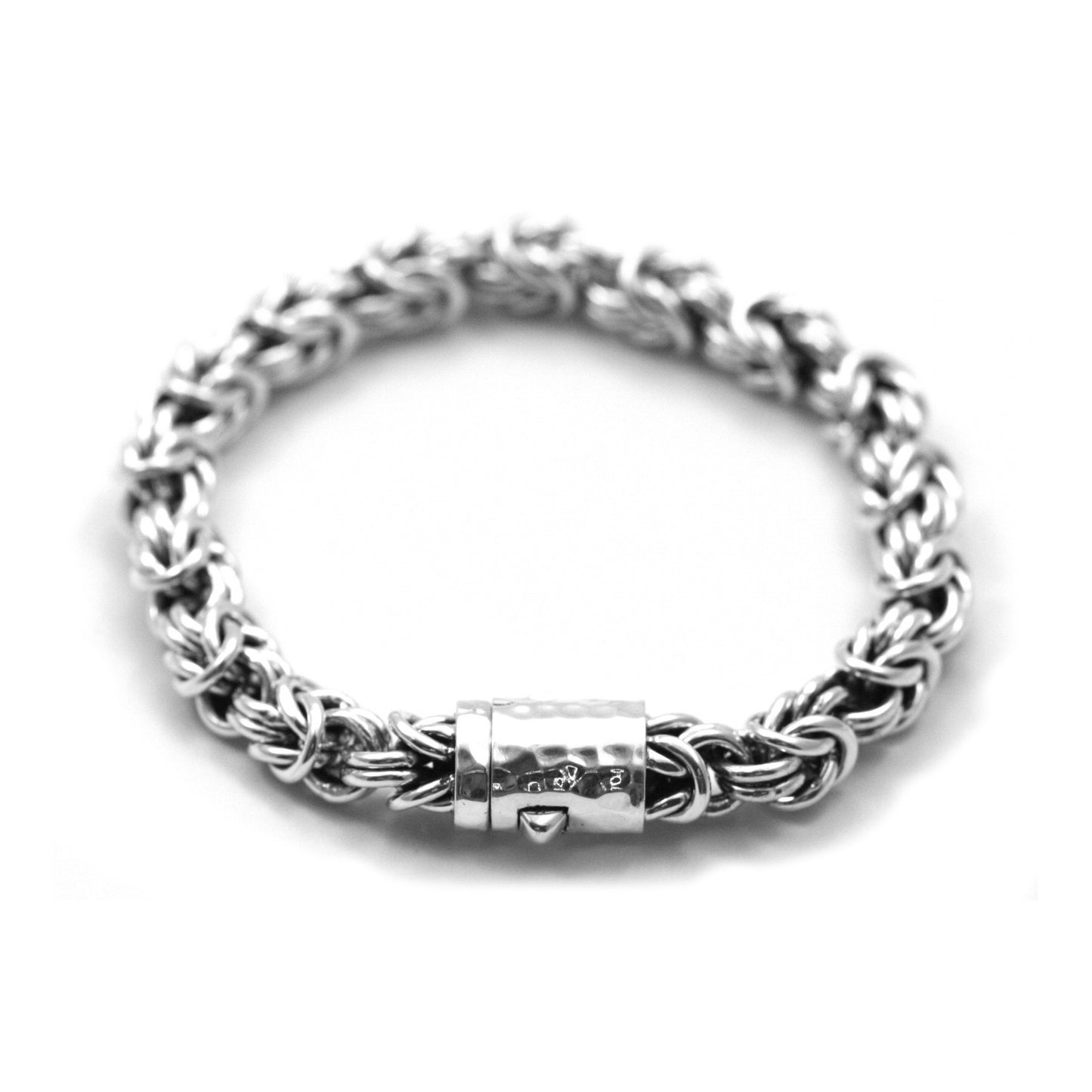 Silver bracelet made of open link byzantine chain with a hammered barrel clasp.