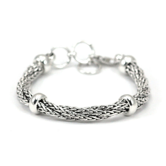 Twisted silver chain bracelet with four polished ring stations.