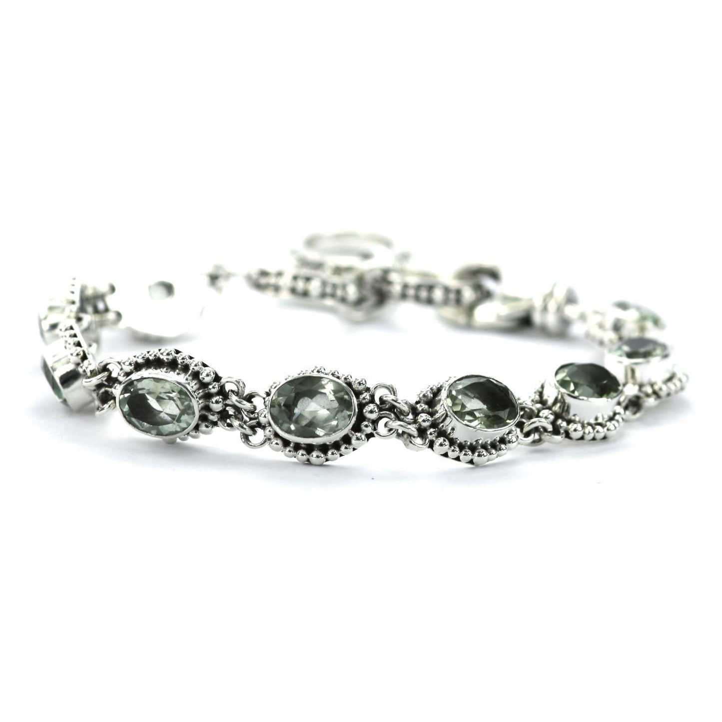 Silver link bracelet with nine green amethyst gemstones and beaded accents.
